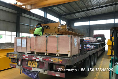 Electric overhead cranes loaded into truck to leave factory for delivery to Uganda