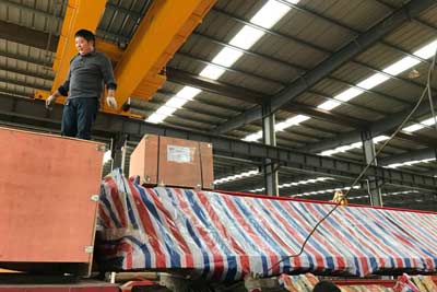 Complete overhead crane system and kits are packed and loaded into truck for delivery pakistan