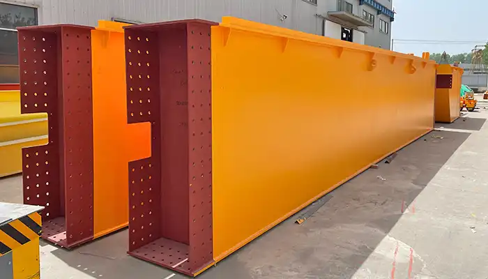 Heavy-duty crane girder sections being loaded onto flat-rack containers for ocean shipment.