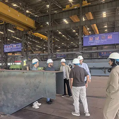 Saudi Arabia customer delegation touring Yuantai Crane's manufacturing facility for overhead crane project evaluation and future cooperation.