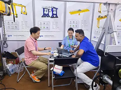 International customers consulting with Yuantai Cranes about customized overhead crane systems, FEM/DIN hoists, and turnkey lifting solutions at the Canton Fair.