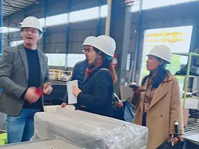 Spanish customers checking overhead crane components at Yuantai Crane manufacturing workshop
