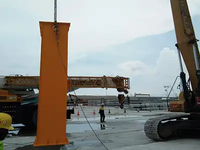 Yuantai Cranes is supplying Singapore with one 100 ton rubber tyred gantry crane for construction site use. This 100 ton RTG crane spans 11.5 meters with a 6-meter lifting height, runs on 380V/50Hz/3P power, and features heavy-duty tyres for mobility on unpaved ground — ideal for precast concrete yard and steel structure erection.